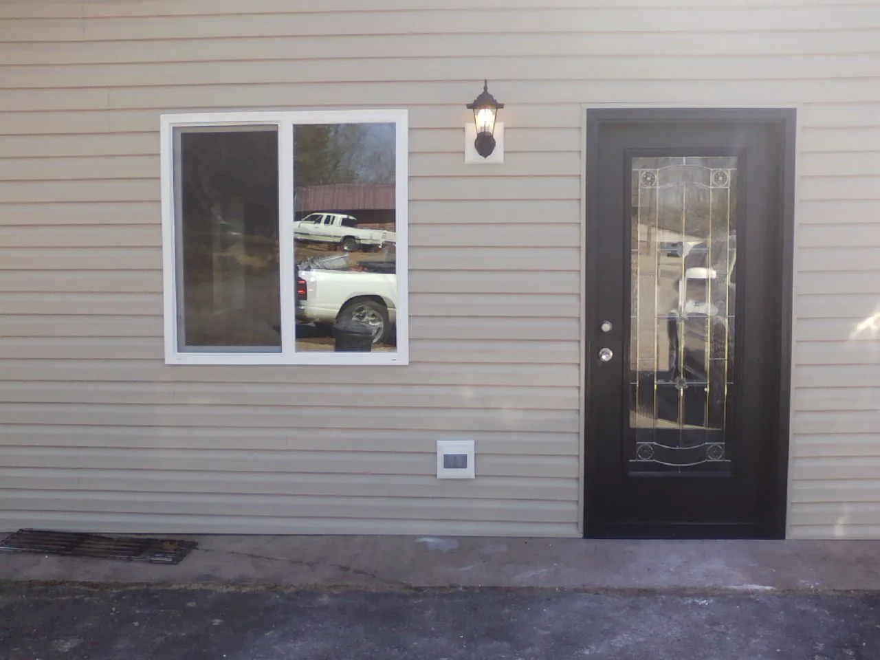 New siding, window and entry door on the side of an addition in Franklinville